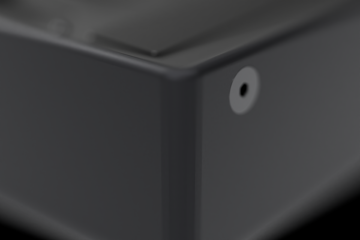 Corner of the black anodized aluminum enclosure, showing the machined edge and a rear fastener.